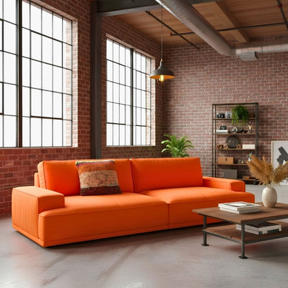 Kissen Rust Blossom auf orangefarbenem Sofa in einem Industrial-Loft mit Sideboard
